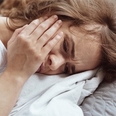 woman toothache in bed for root canal therapy in Sunnyvale