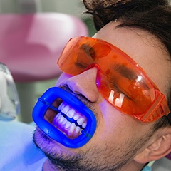 Man receiving in-office whitening treatment