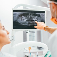 Dentist and patient looking at digital x-rays