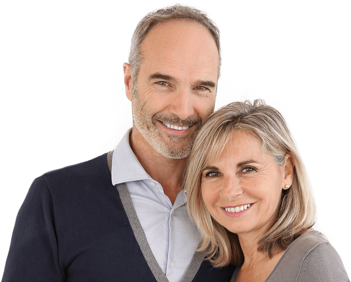 Older man and woman smiling while standing next to each other