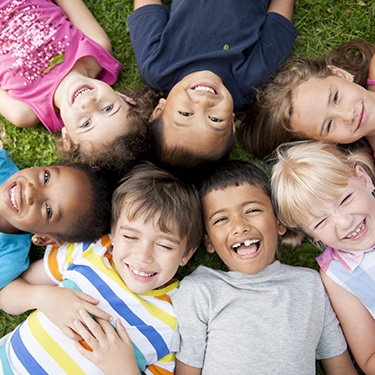 Group of kids smiling together outdoors