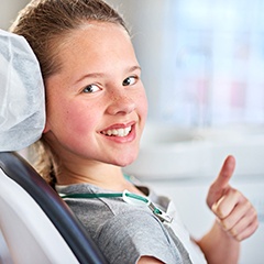 Young girl giving thumbs up