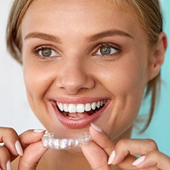 Woman placing Invisalign tray