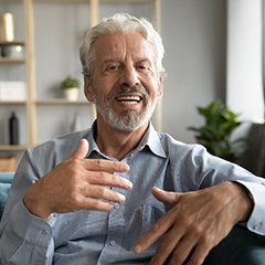 An older man speaking with someone off-camera