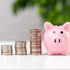 Piggy bank by money for cost of dentures in Sunnyvale