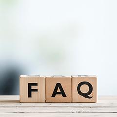 Three wooden letter blocks on ledge spelling FAQ