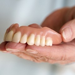 Holding dentures