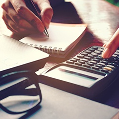 Woman calculating cost of emergency dentistry in Sunnyvale