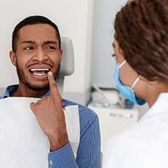 Man showing his Sunnyvale emergency dentist his toothache