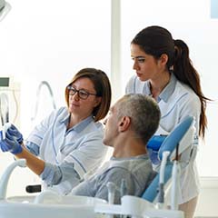 Dentist and patient discussing  the cost of dental emergencies in Sunnyvale