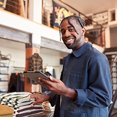 a person smiling and taking inventory at work