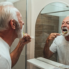 Older man practicing dental implant care in Sunnyvale