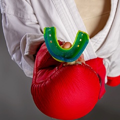 Boxer holding a custom mouthguard