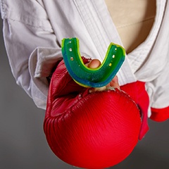 Boxer holding a custom mouthguard