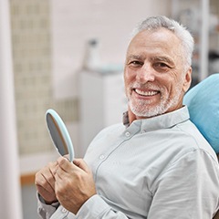 Older man smiling while visiting an implant dentist in Sunnyvale