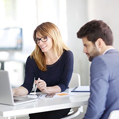 man and woman looking at a laptop together