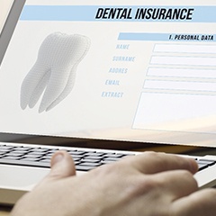 person looking at a dental insurance form on a laptop