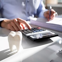 person typing on a calculator