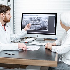 dentist showing a patient her dental X-rays