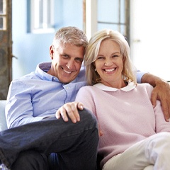 couple lounging on their couch after getting dental implants in Sunnyvale