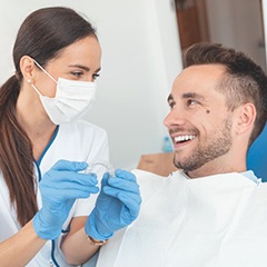 dentist showing Invisalign to a patient 