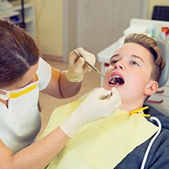 a teenager having their teeth examined