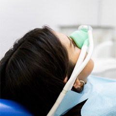 a patient with a mask on her face for nitrous oxide