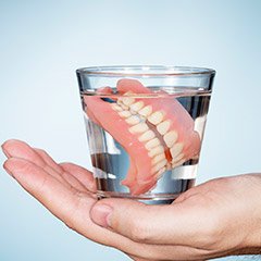 Full dentures in glass of water