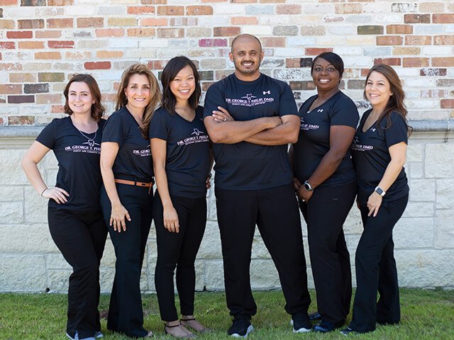 Sunnyvale Texas dentist George T Philip D M D and dental team members smiling outdoors