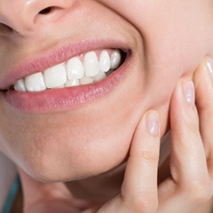 Patient holding jaw in pain