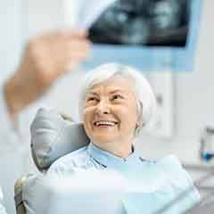 Dentist showing patient her dental X-ray