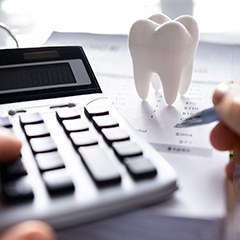 A patient calculating the cost of teeth whitening 