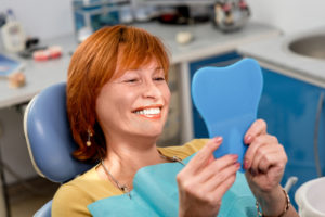 woman looking in dental mirror