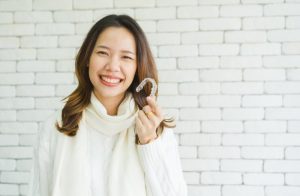 woman holding Invisalign in Sunnyvale