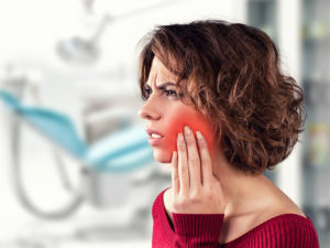Woman with toothache at office of emergency dentist in Sunnyvale