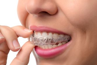 Woman being treated with Invisalign in Sunnyvale putting in a clear tray