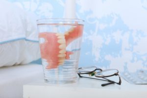 dentures in Sunnyvale in a glass of water on a nightstand