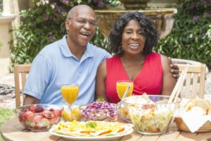 couple with dental implants in Sunnyvale eating outside 