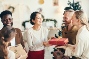 people smiling while gathering during holidays