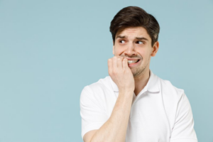 Man nervously biting his nails