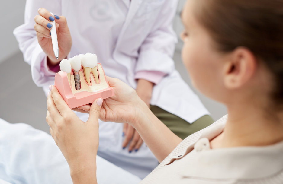 Dentist showing patient dental implant mold