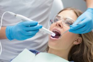 Dentist using intraoral camera on their patient