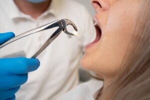 Woman getting her tooth removed